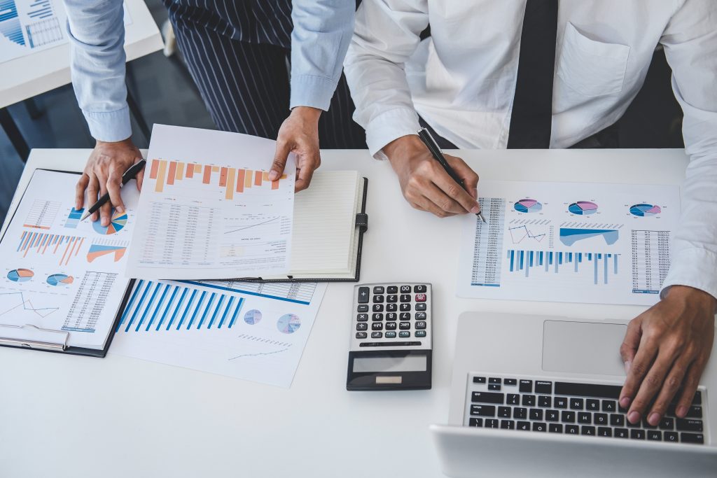 Business team working on financial data sheets.